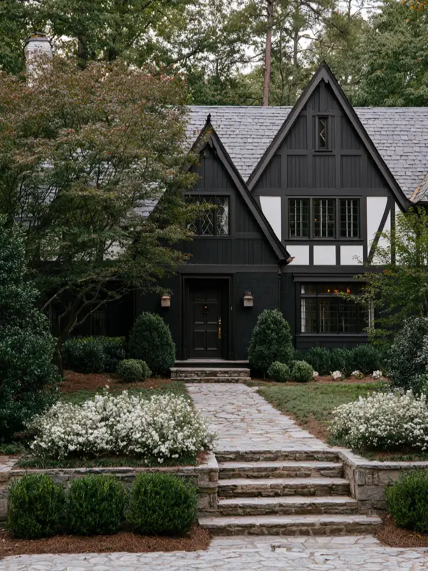 Black Tudor style house exterior with white half-timbering, steep gables and leaded glass windows
