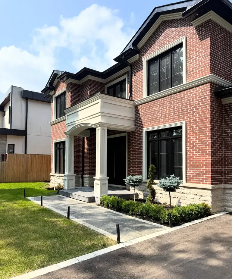 Cream and Stone — Cream cast-stone trim and a pale limestone base wrap this red brick facade