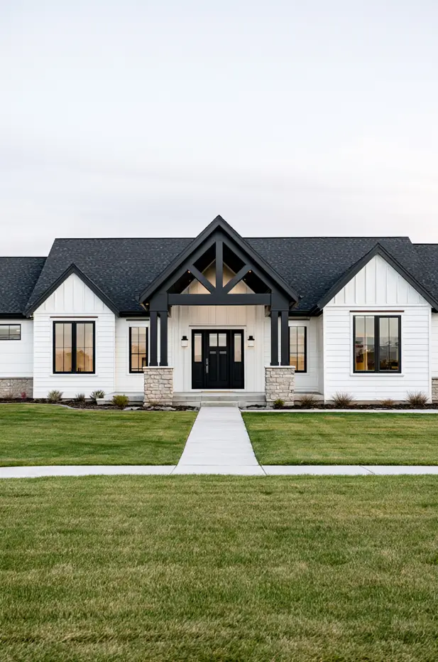 Single-story white modern ranch with a central timber-truss gable entry, stone columns, black windows, and low side gables